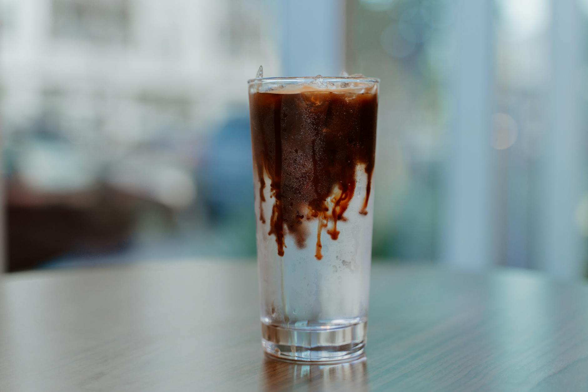 https://www.pexels.com/photo/selective-focus-of-an-ice-coffee-on-wooden-surface-4921594/